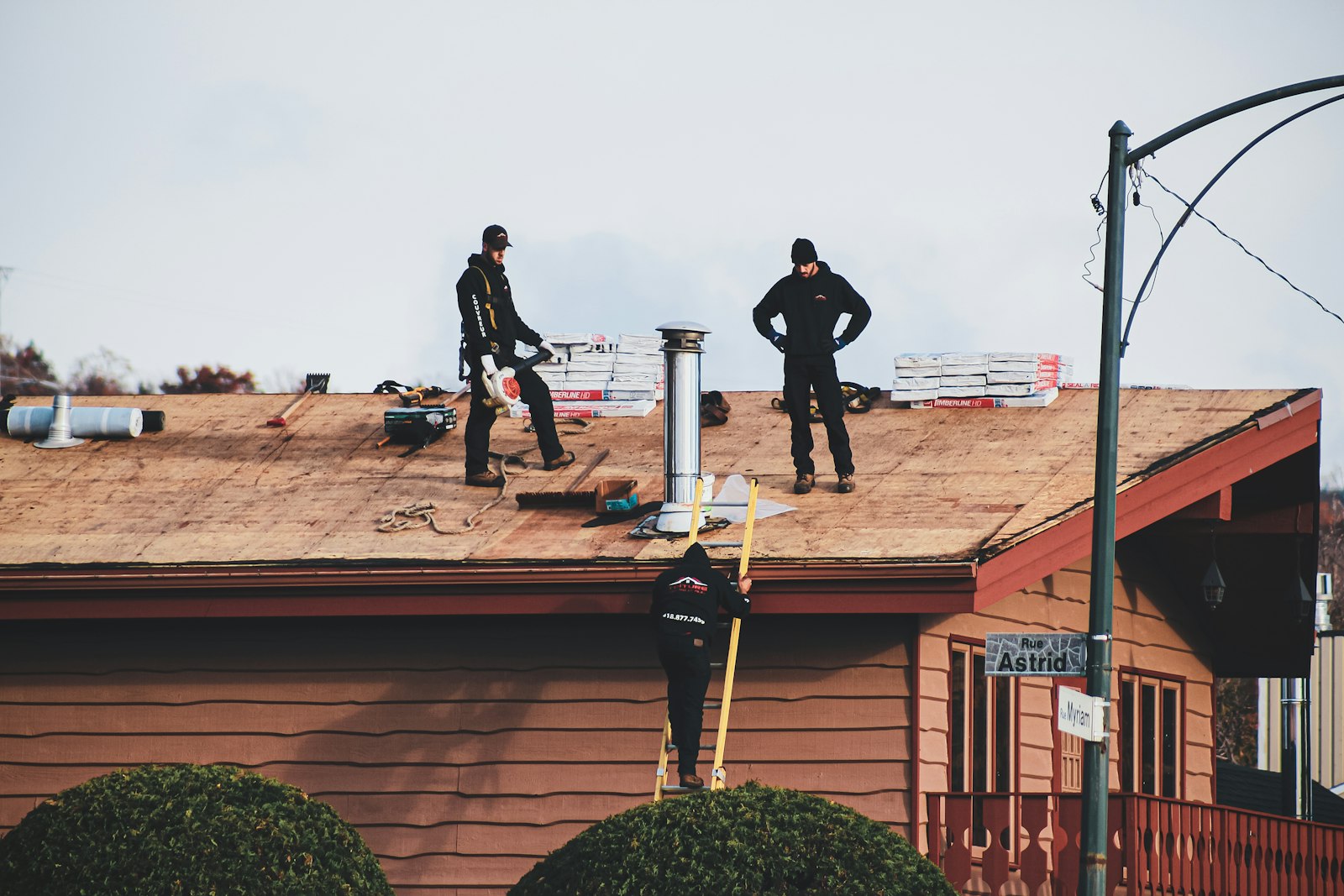 A Hammer Down roofing crew working on an open roof deck