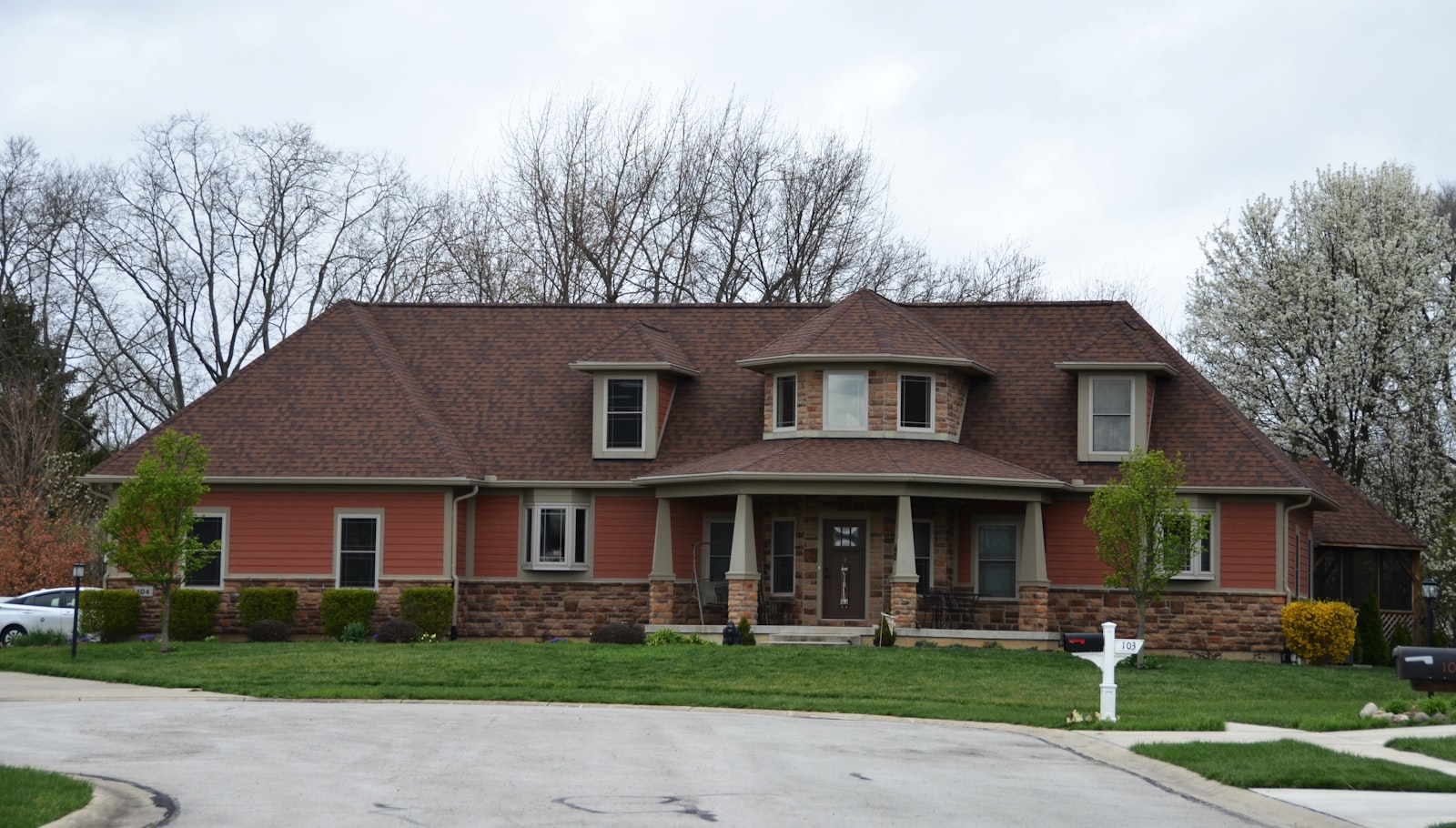 Large suburban home with an architectural shingle roof, the kind of property Hammer Down helps with insurance claims