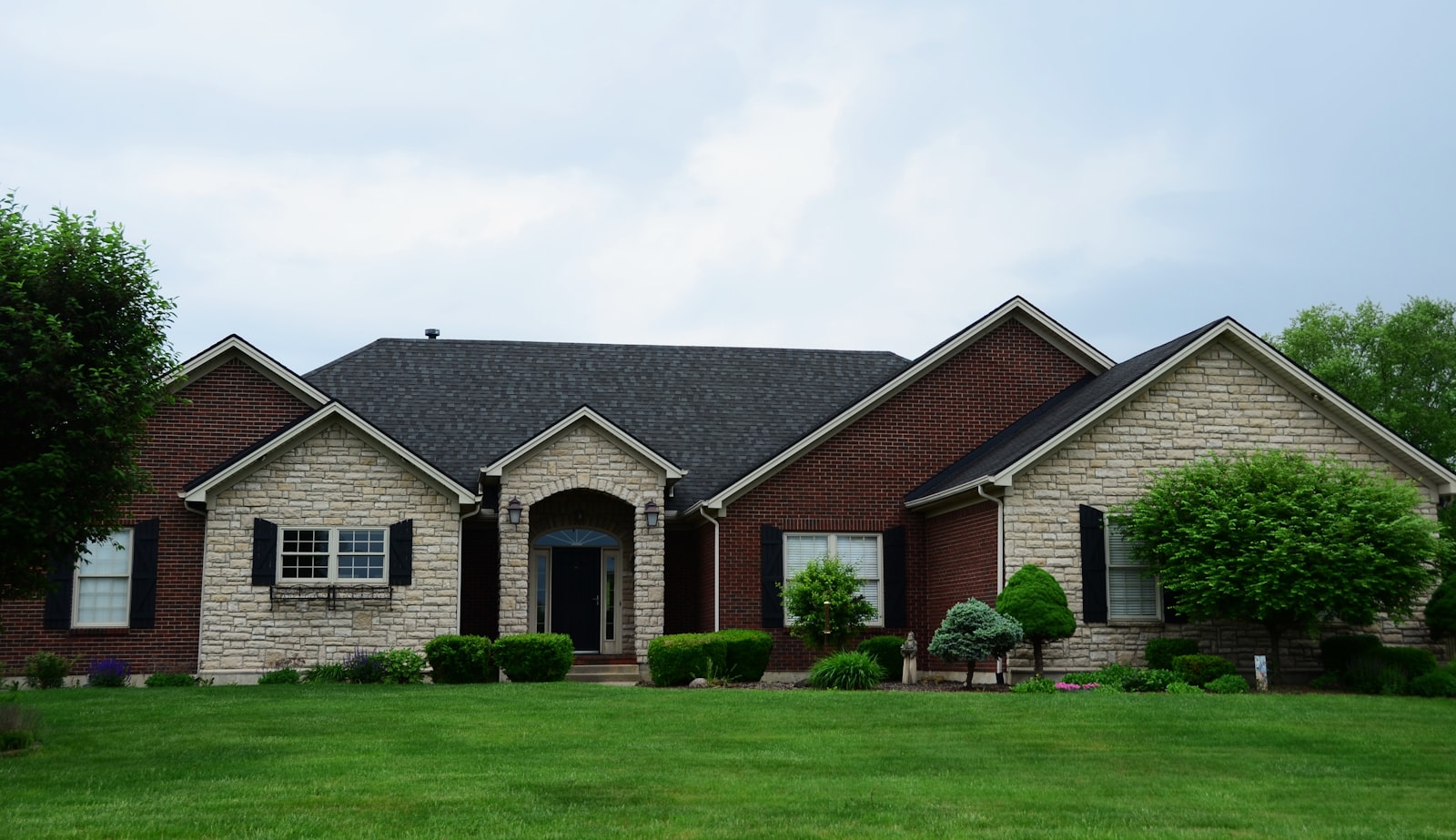 A well-maintained home with a clean, new-looking dark architectural shingle roof