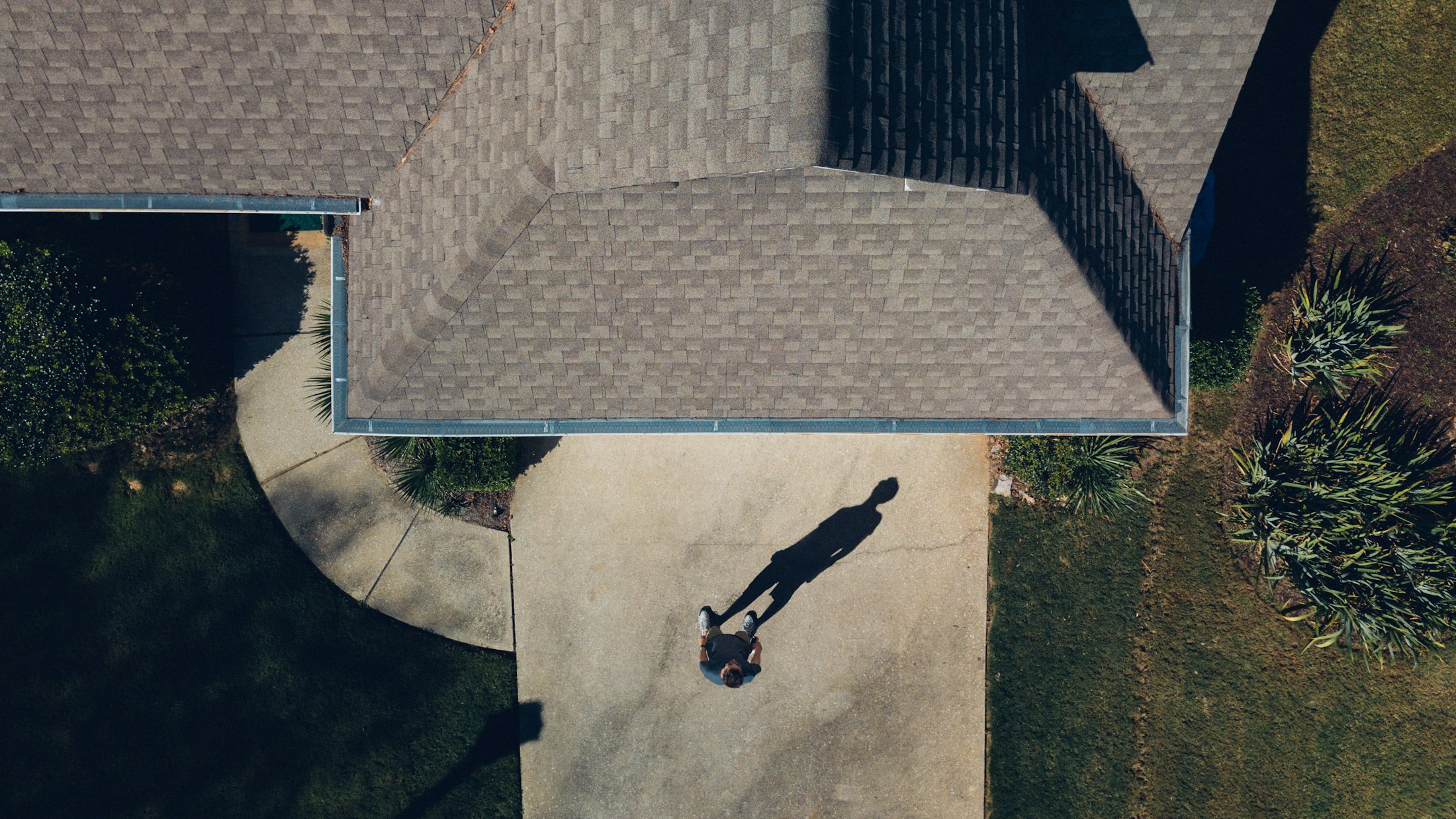 Aerial drone view of a Missouri suburban home's asphalt shingle roof