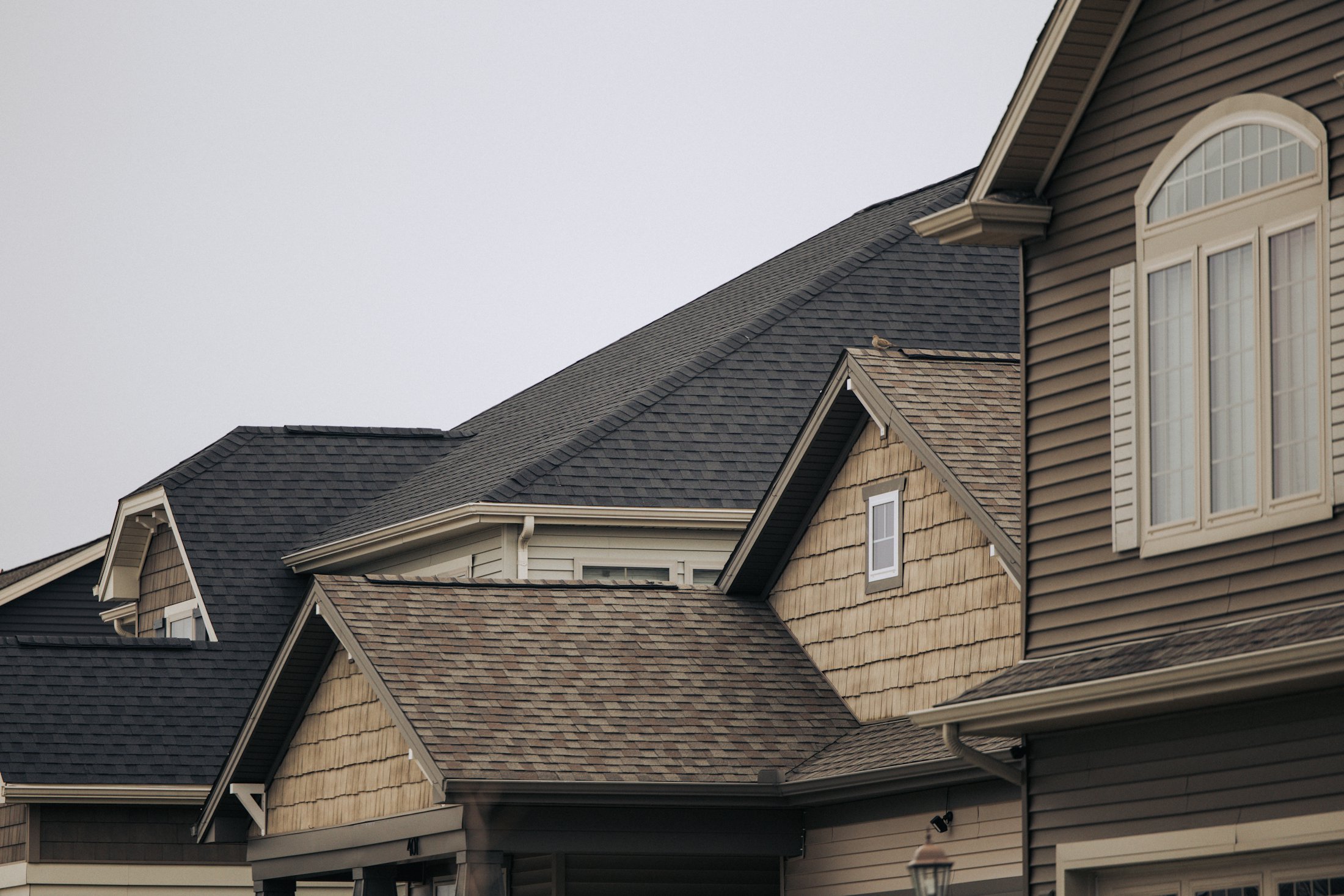 Row of Missouri suburban homes with dark architectural shingle roofs