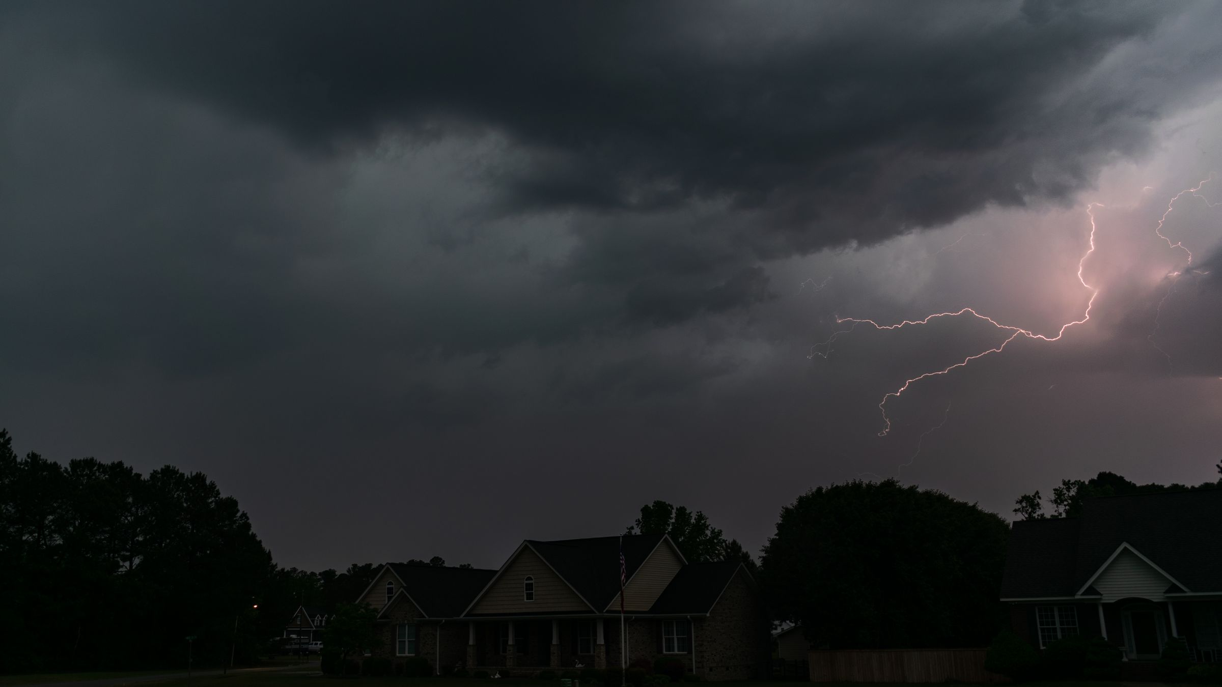 Lightning storm over a suburban Missouri neighborhood at dusk